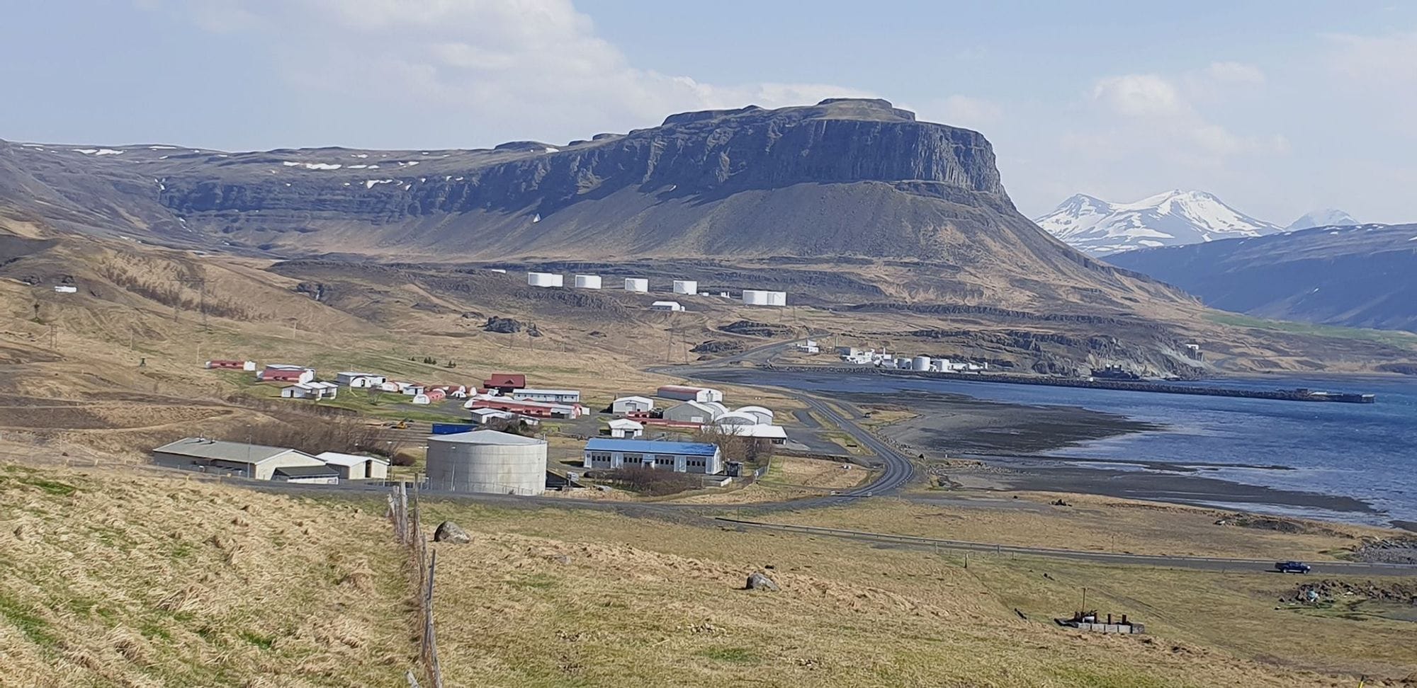 A rural landscape with green field and  mountain 