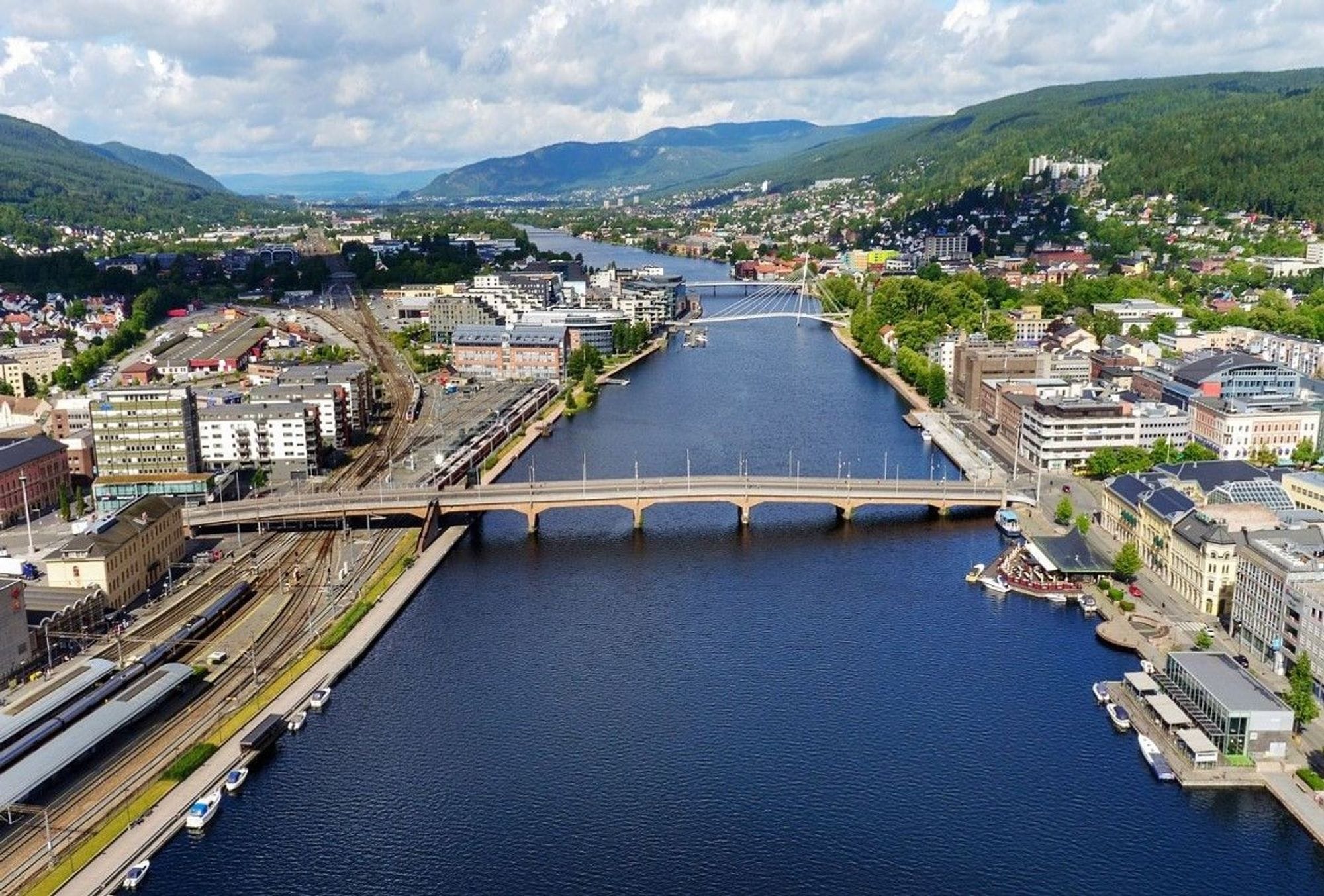 Blue river running through a city with a bridge spanning across it
