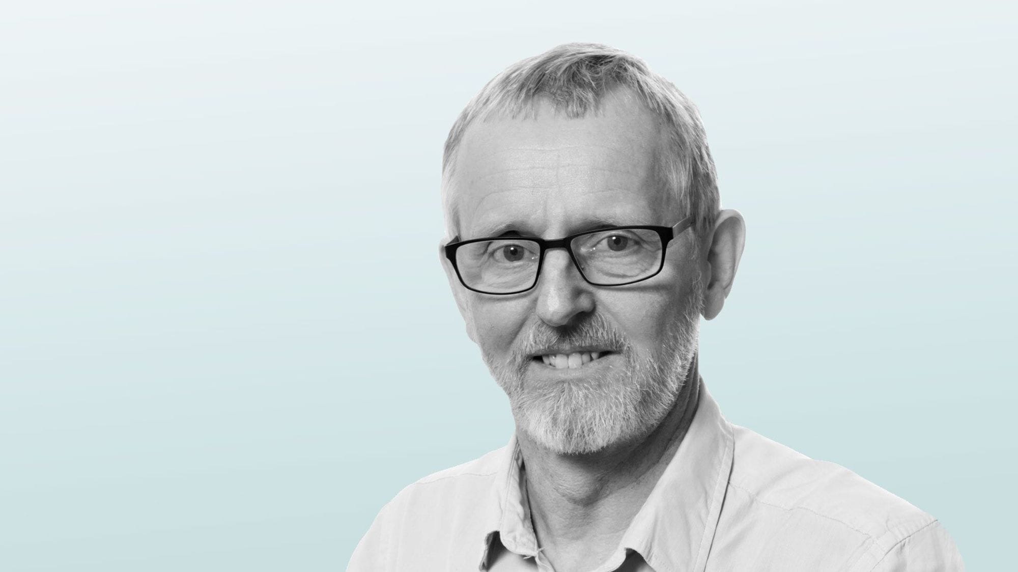 A portrait of a man with glasses