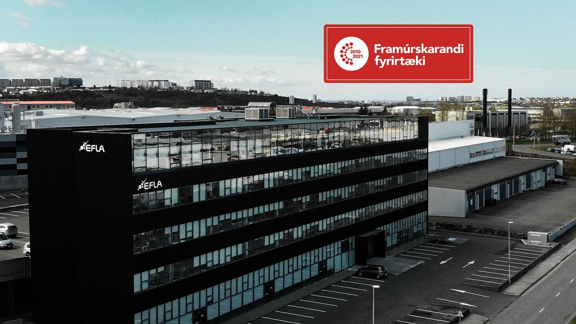 Black office building with the logo of EFLA on its facade some texts in a red box 