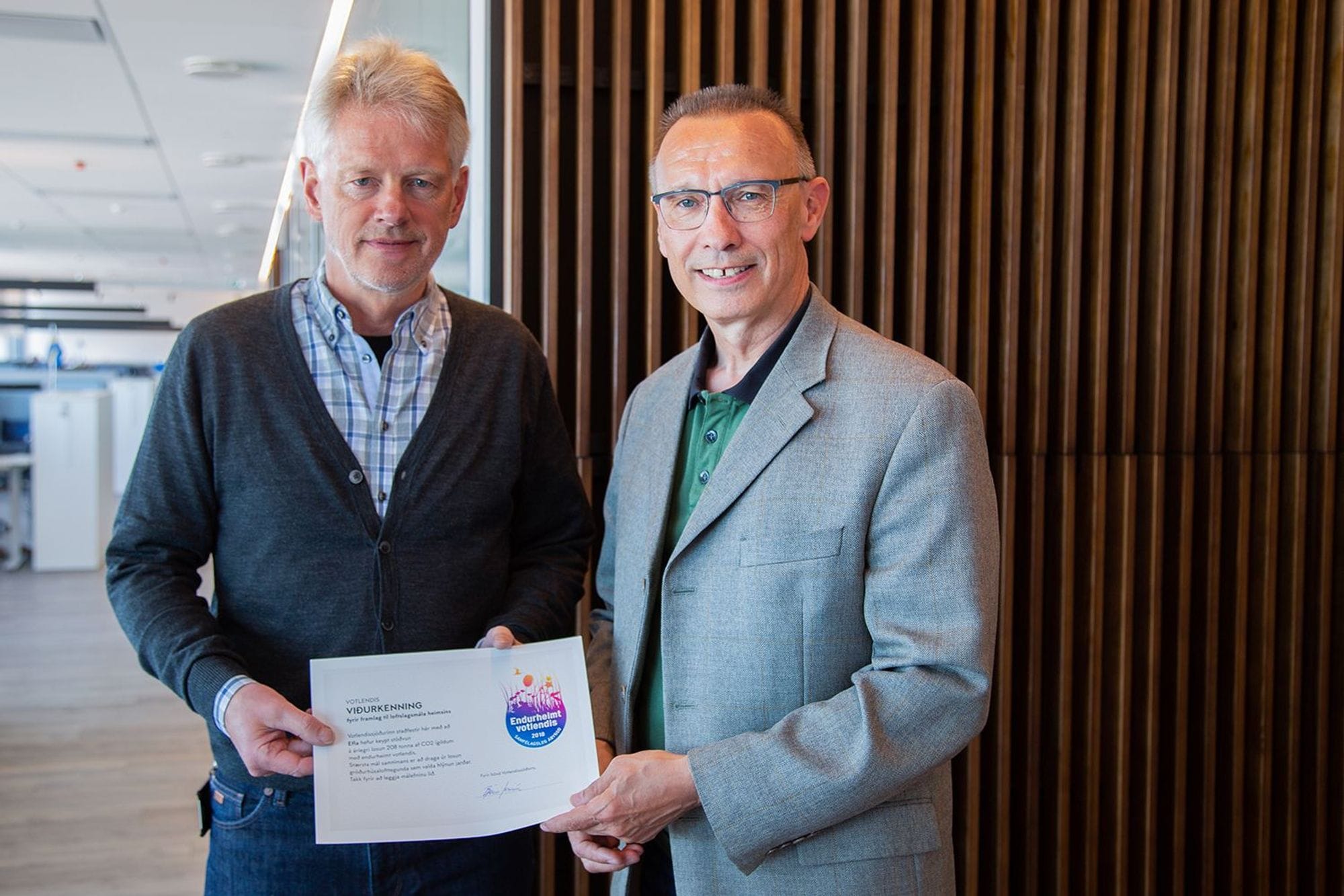 Two men holding a certification together