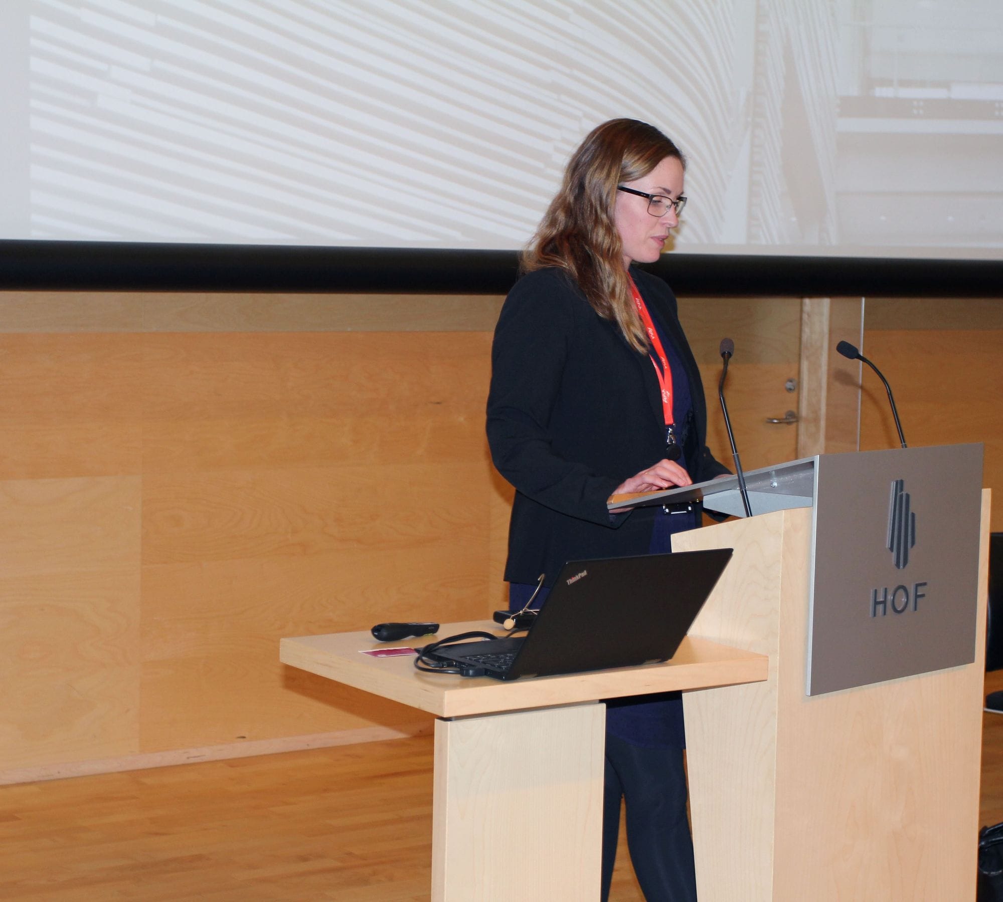 a woman giving speech at a conference