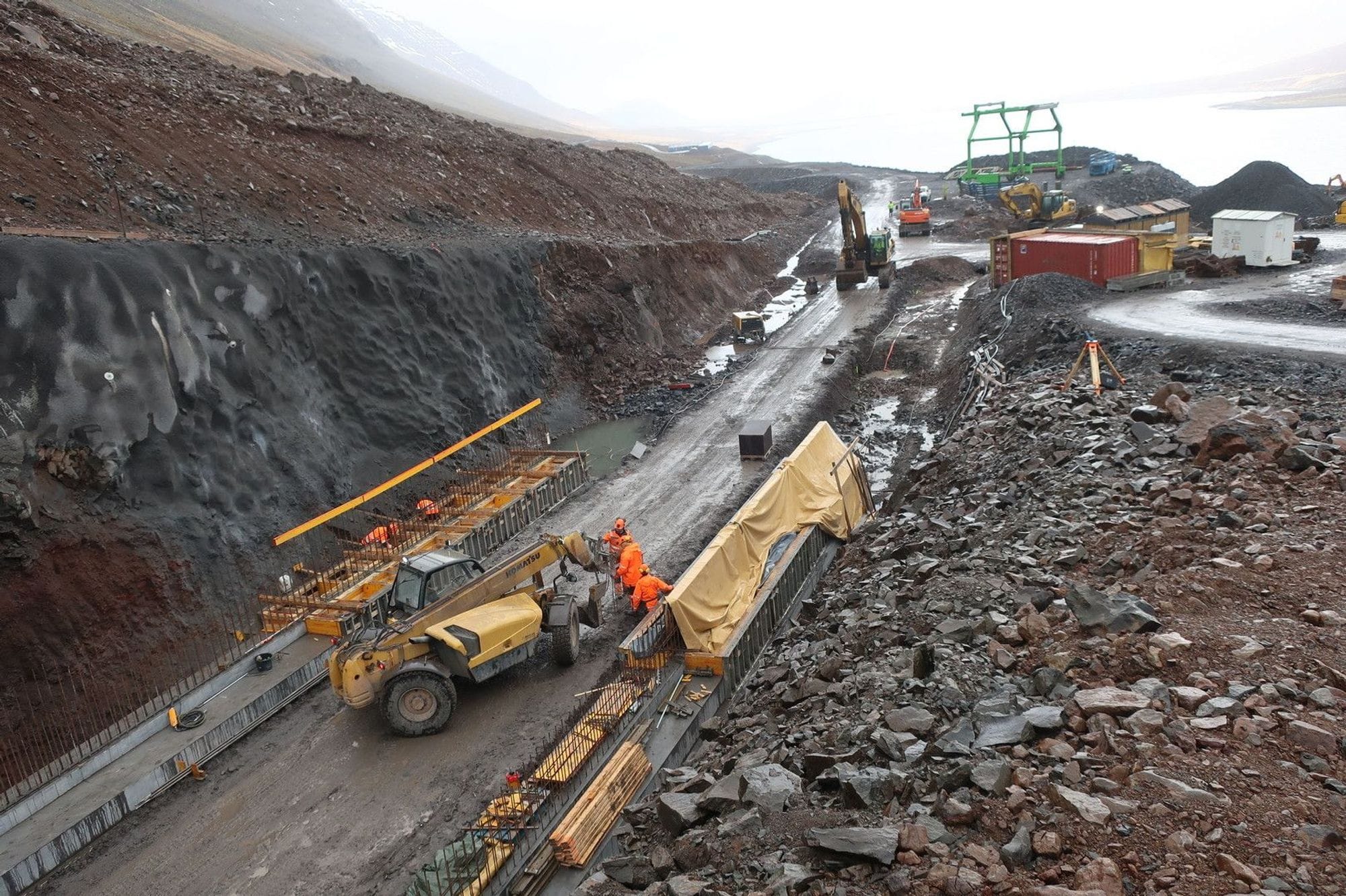 A construction site heavy machinery and workers 