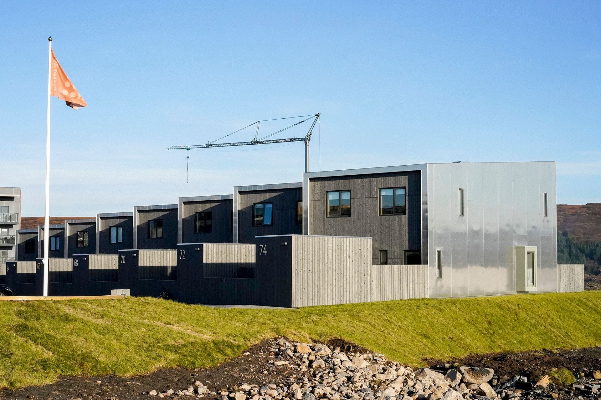 A row of modern, cubic, grey residential buildings