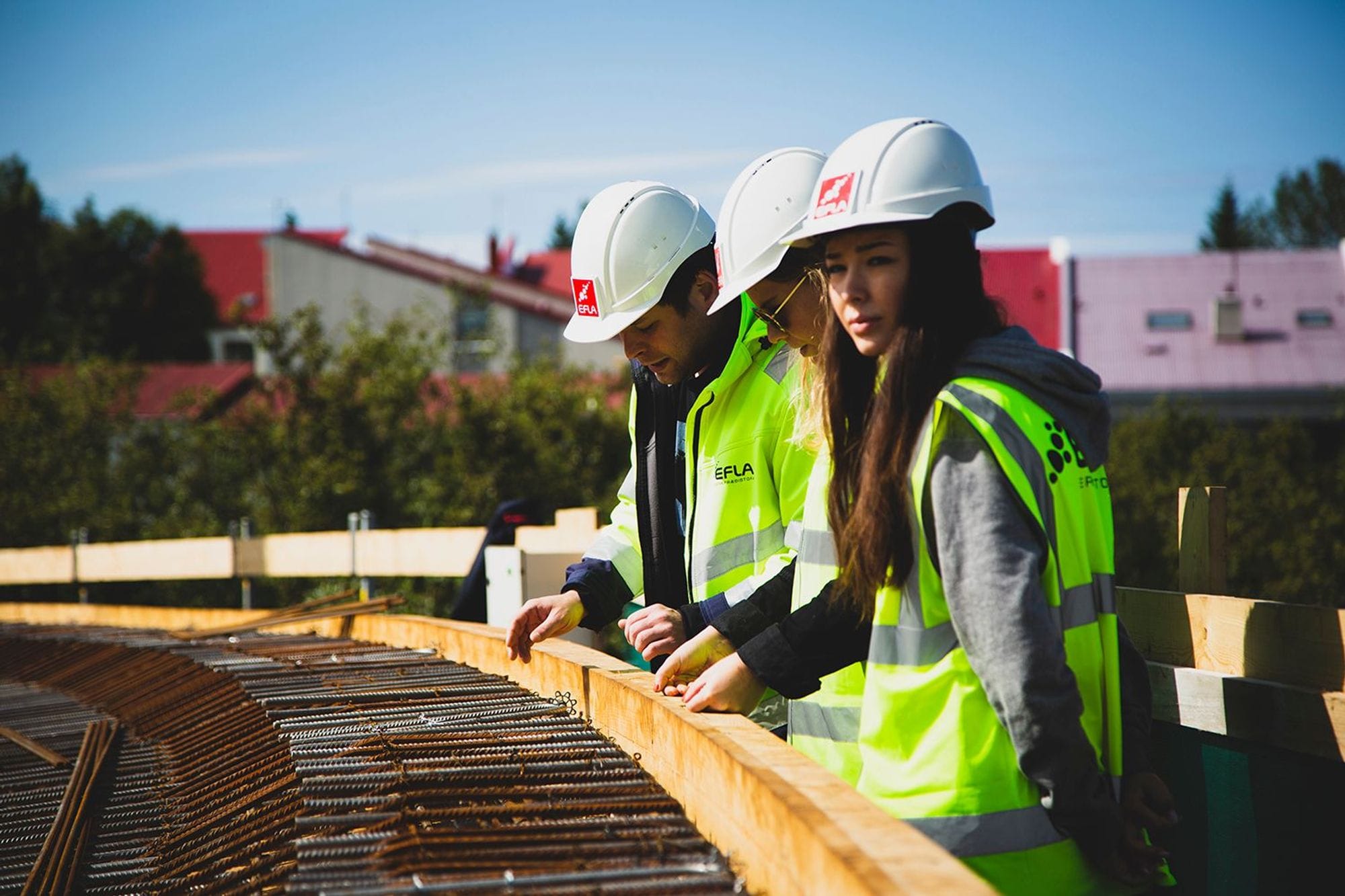 Three construction worker examining the rebar reinforcement