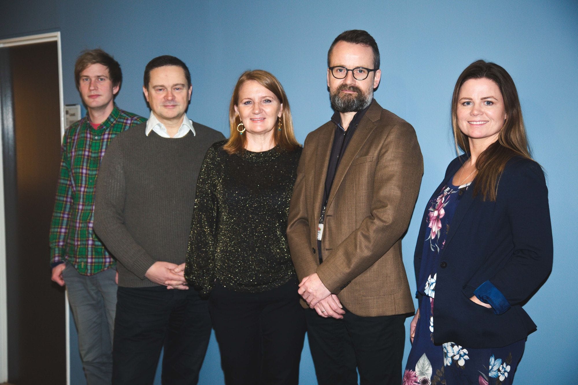 A group of people standing together and posing for the picture