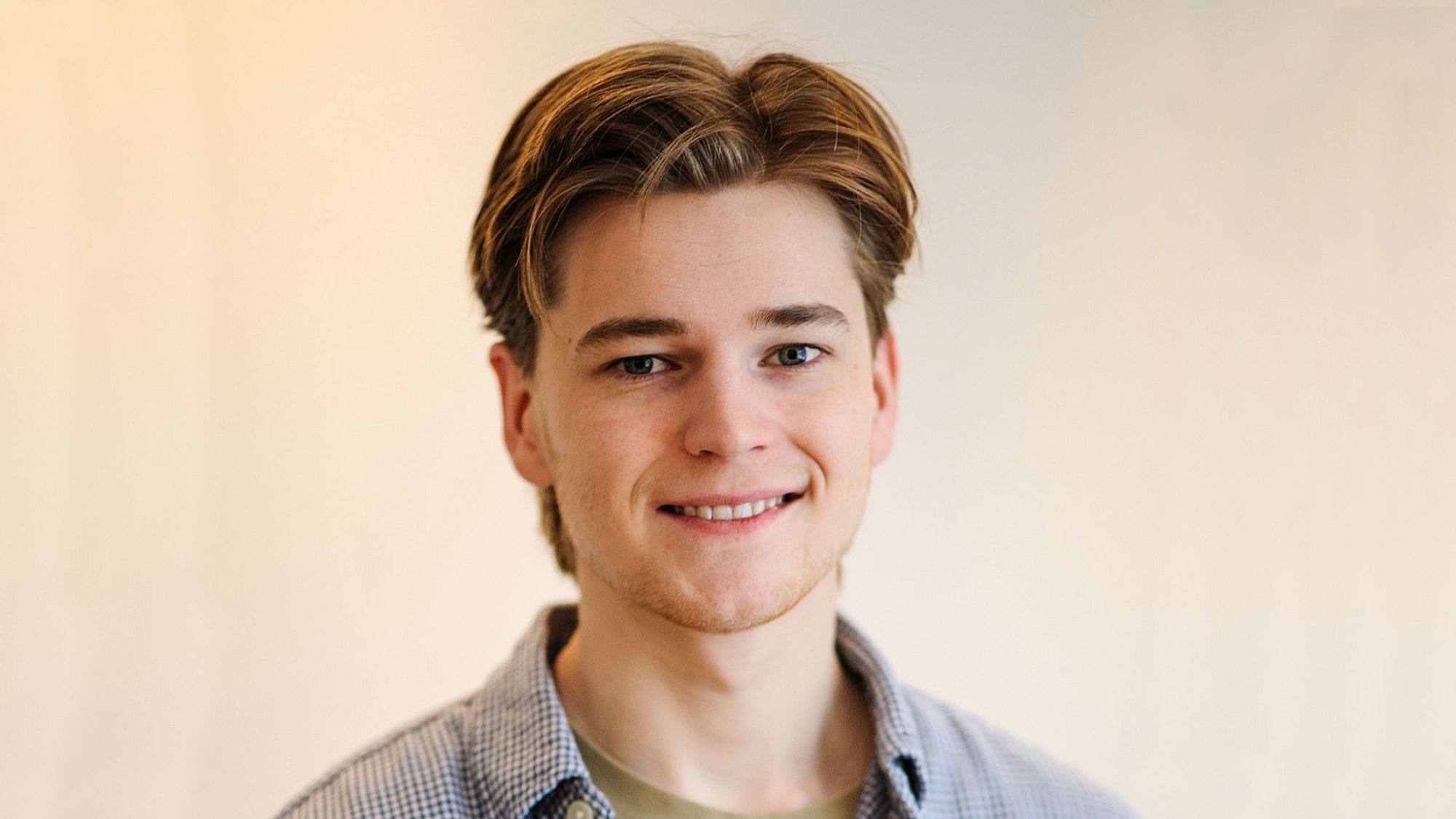 A portrait of a young man with a big smile
