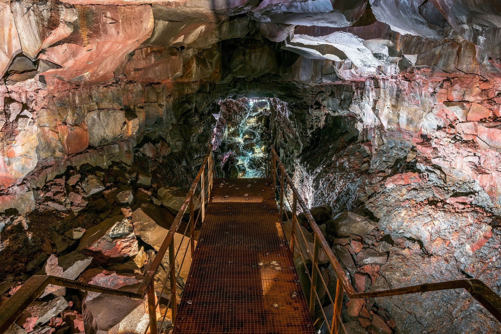 metal stairs leading down to a cave