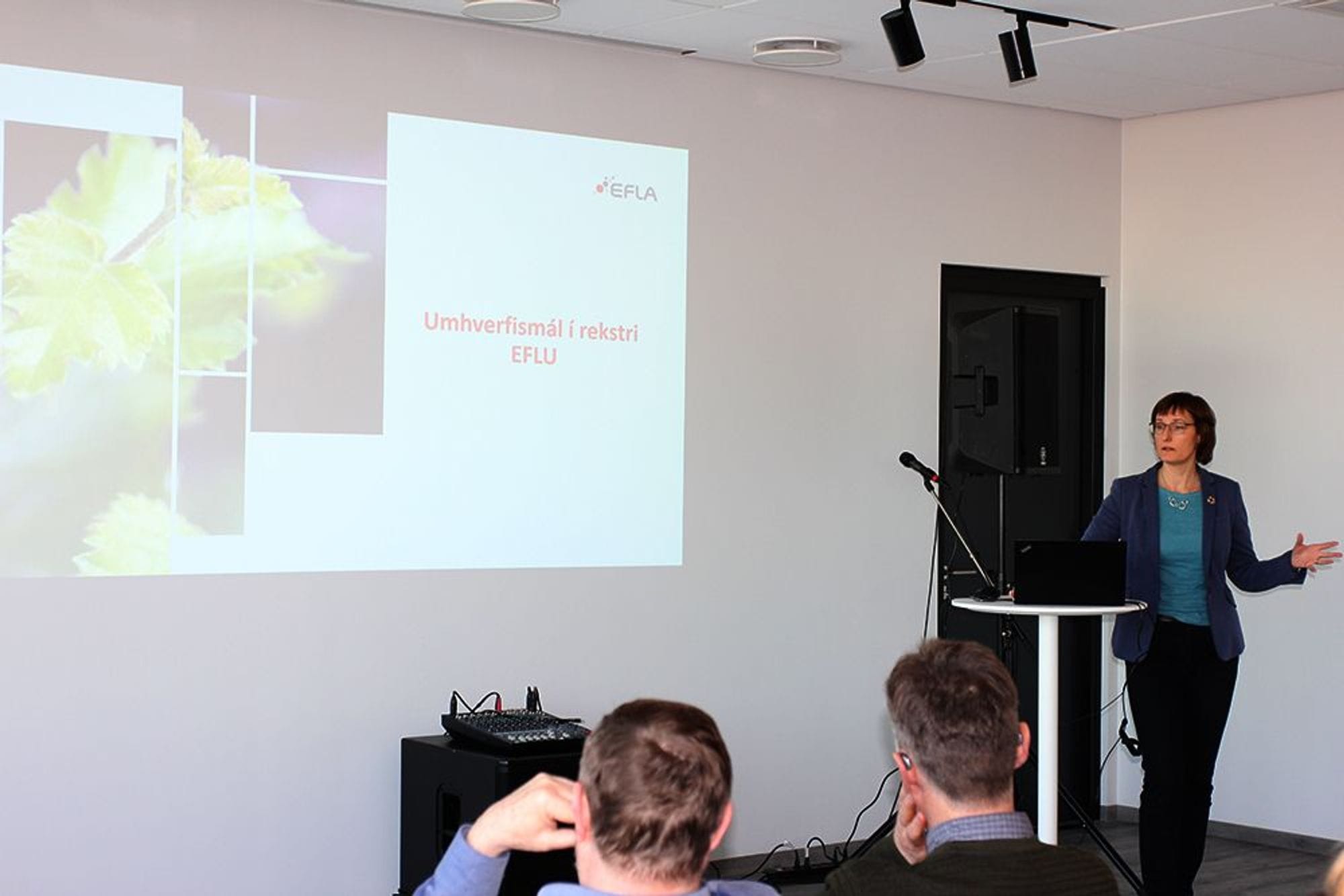 A woman presenting in front of audience 