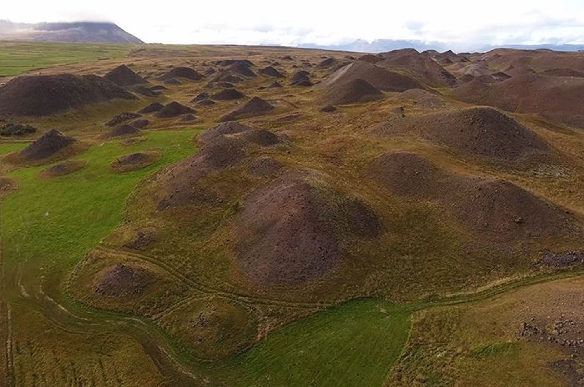 landscape of hilly terrain with various shades of brown and green
