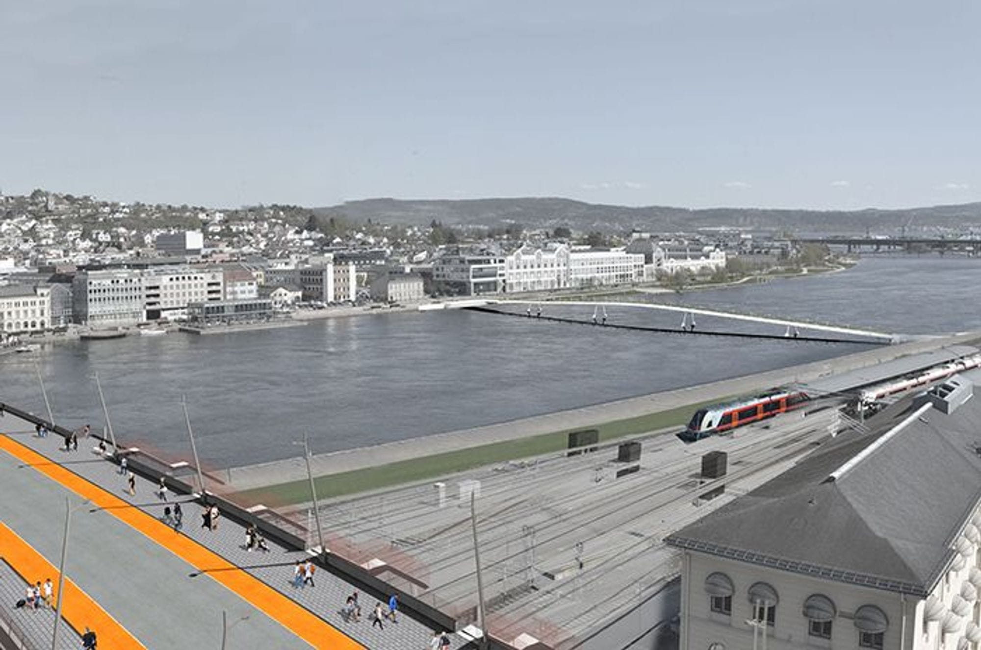 A train running alongside a pedestrian path, with crossing a a large bridge over a waterway