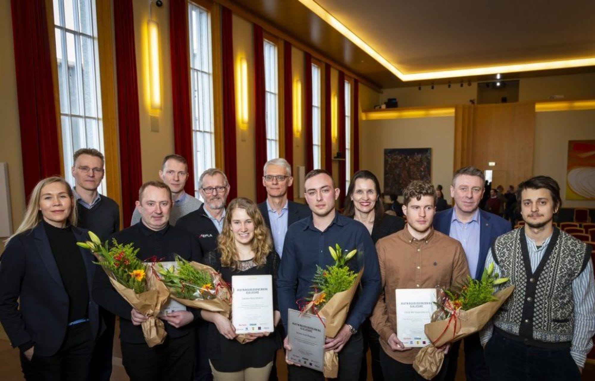 A group of men and women standing with certificates in their hands 