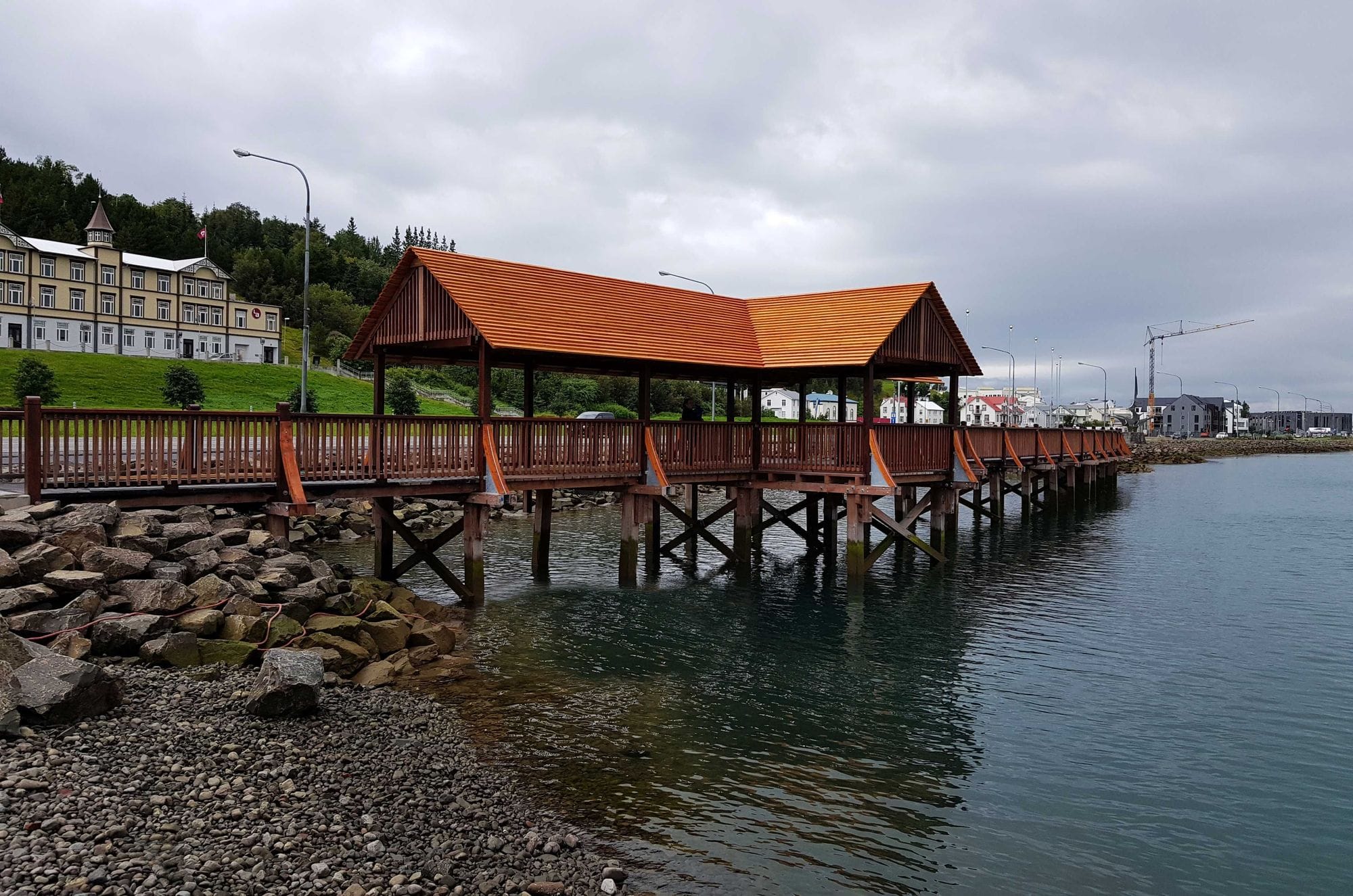 Wooden pedestrian bridge with distinctive roof by the water