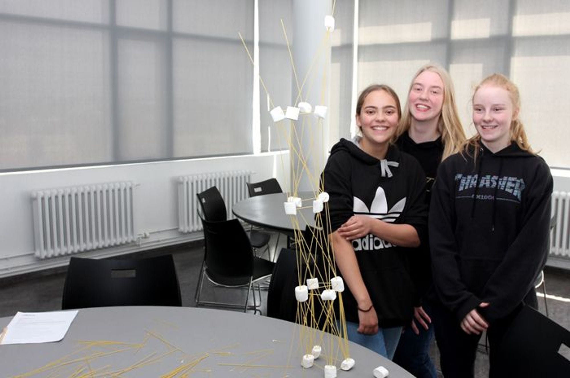 Three girls posing with smiling faces