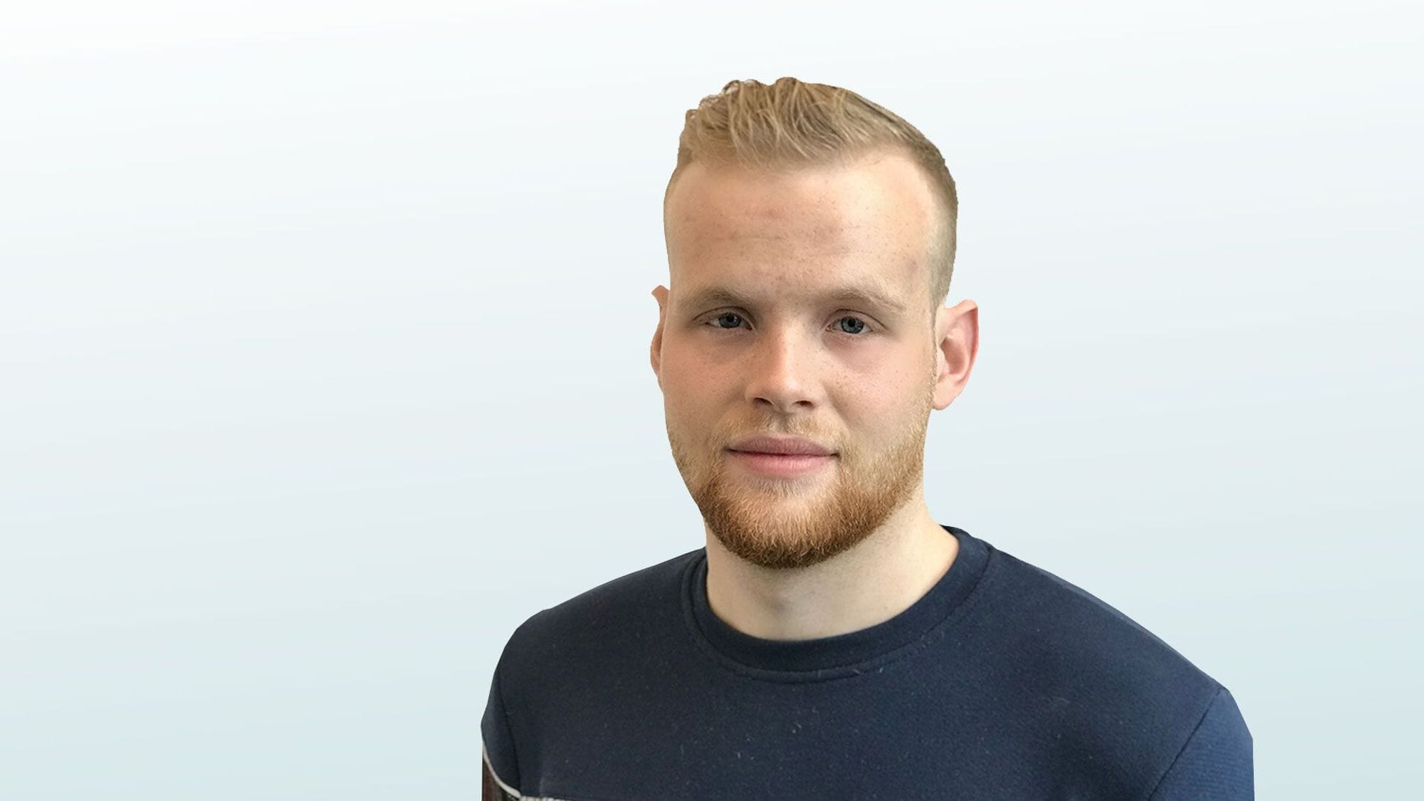 A portrait of a young man with short blond hair and beard