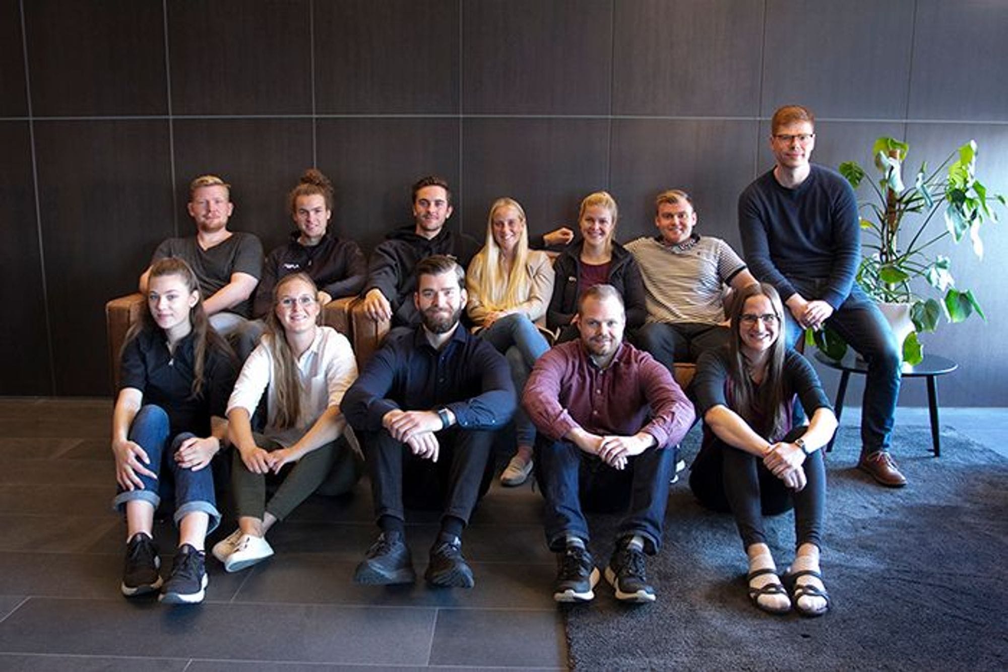 Individuals seated in two rows, smiling and posing for the picture