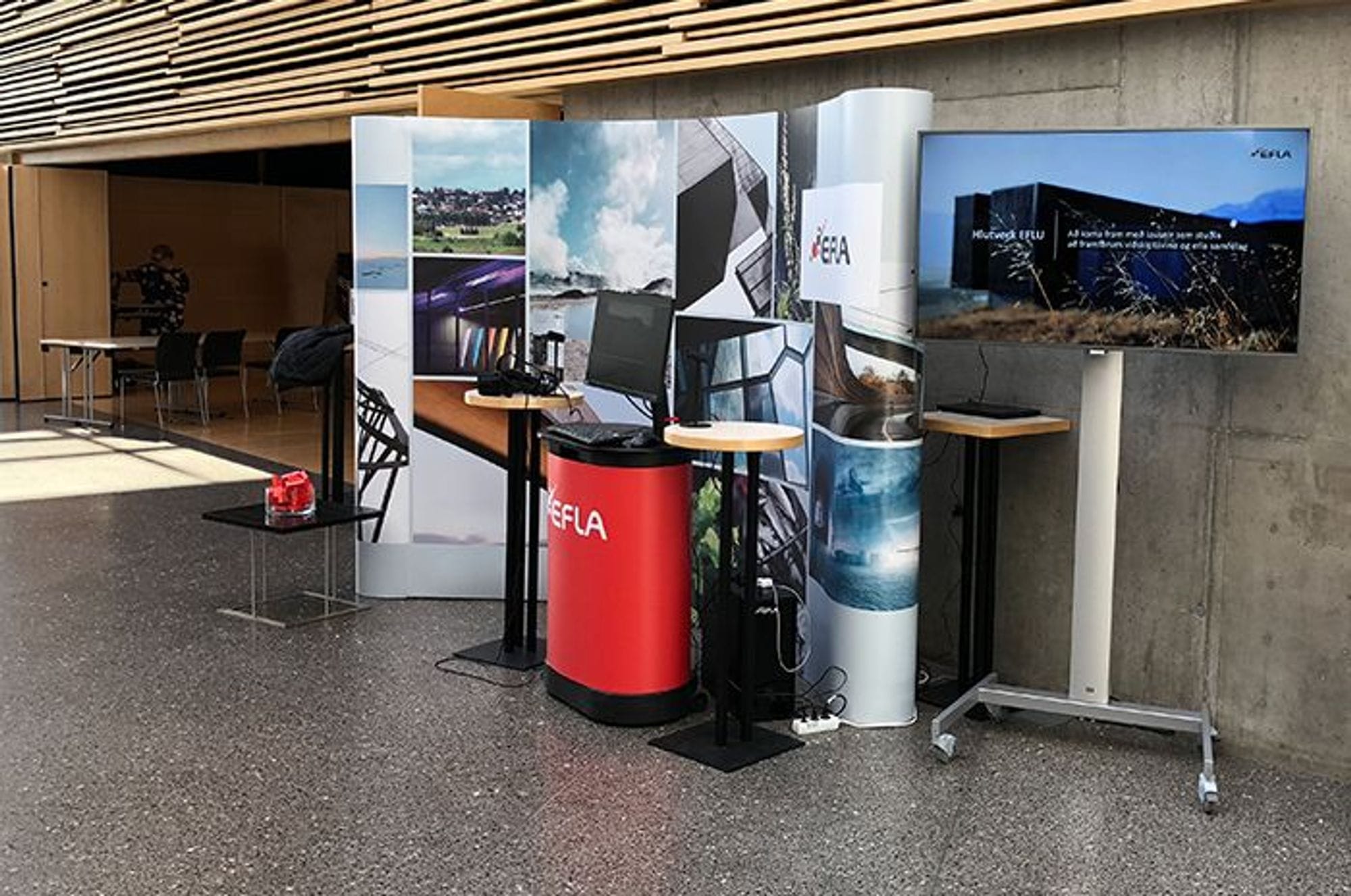 An informational booth with banners, monitors and desks