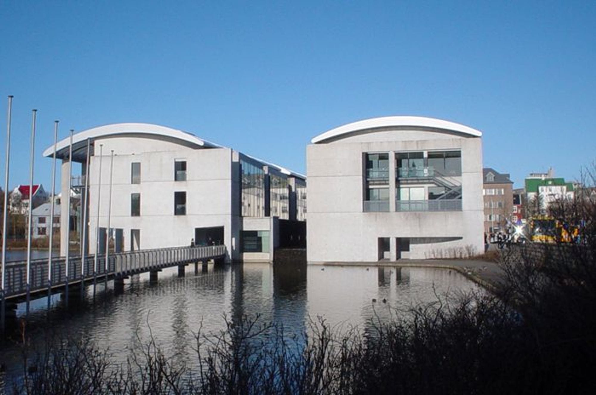white building with unique rounded design roof situated on the waterfront