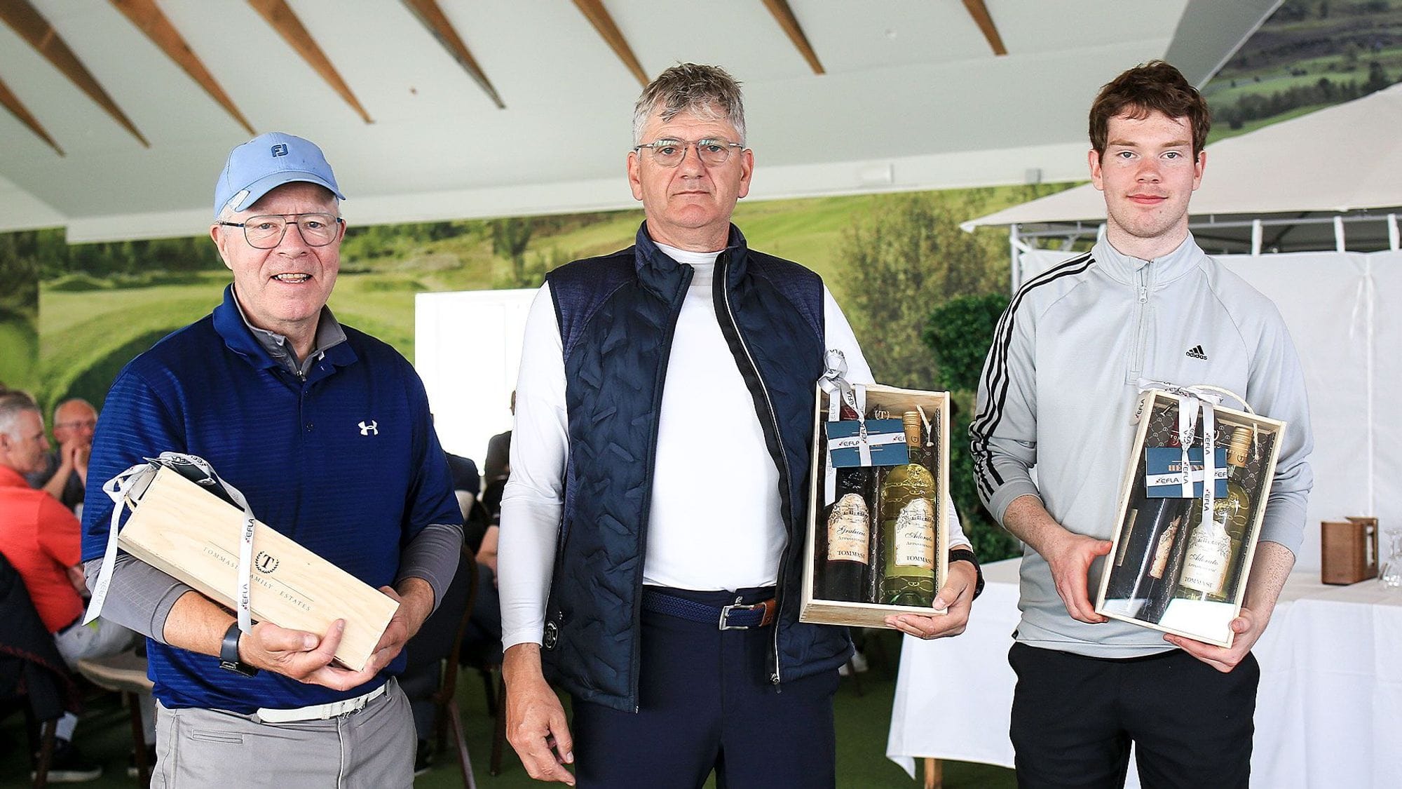 Three men posing with wooden wine boxes