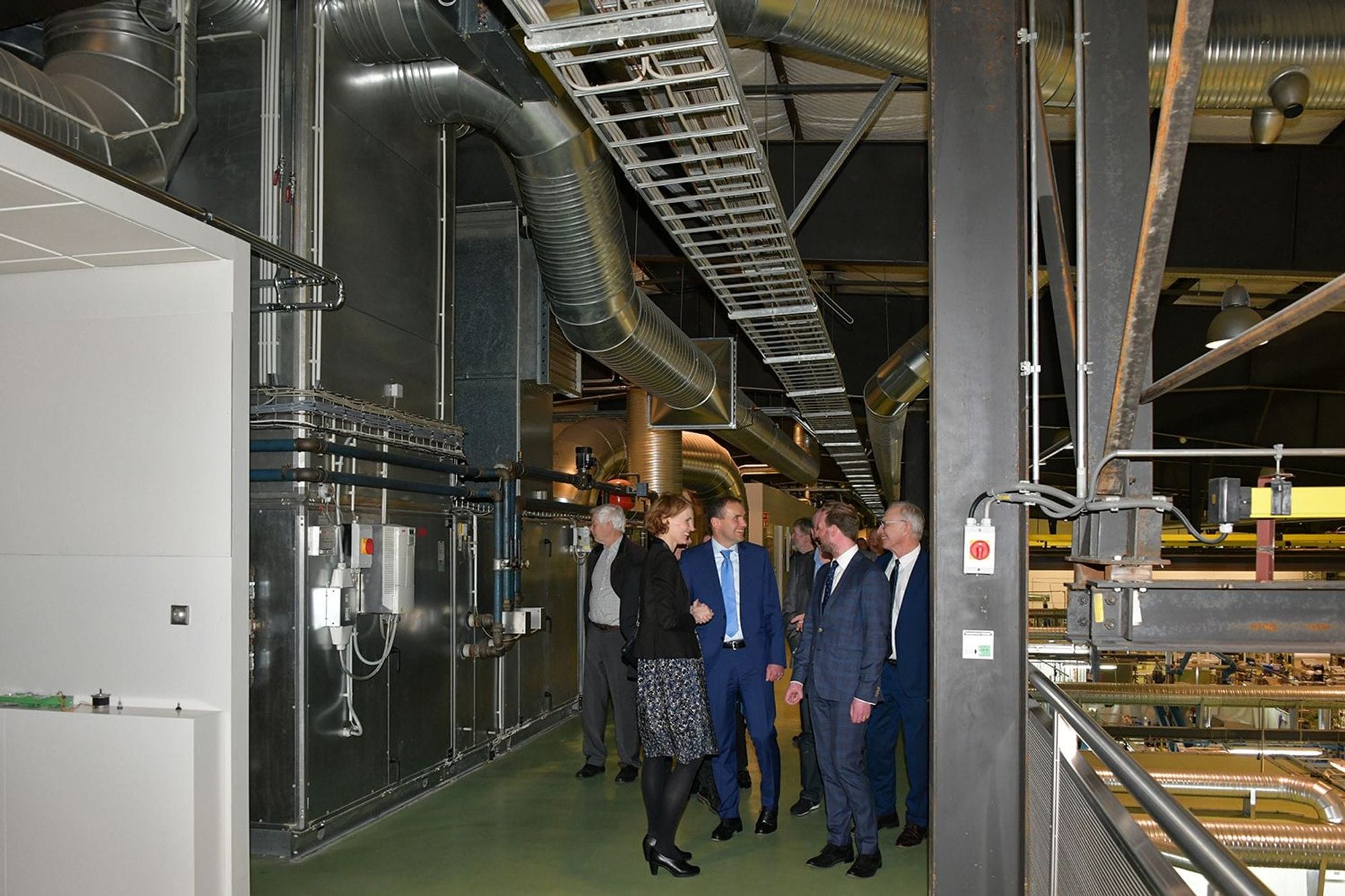 A group of people engaging in a discussion in a factory