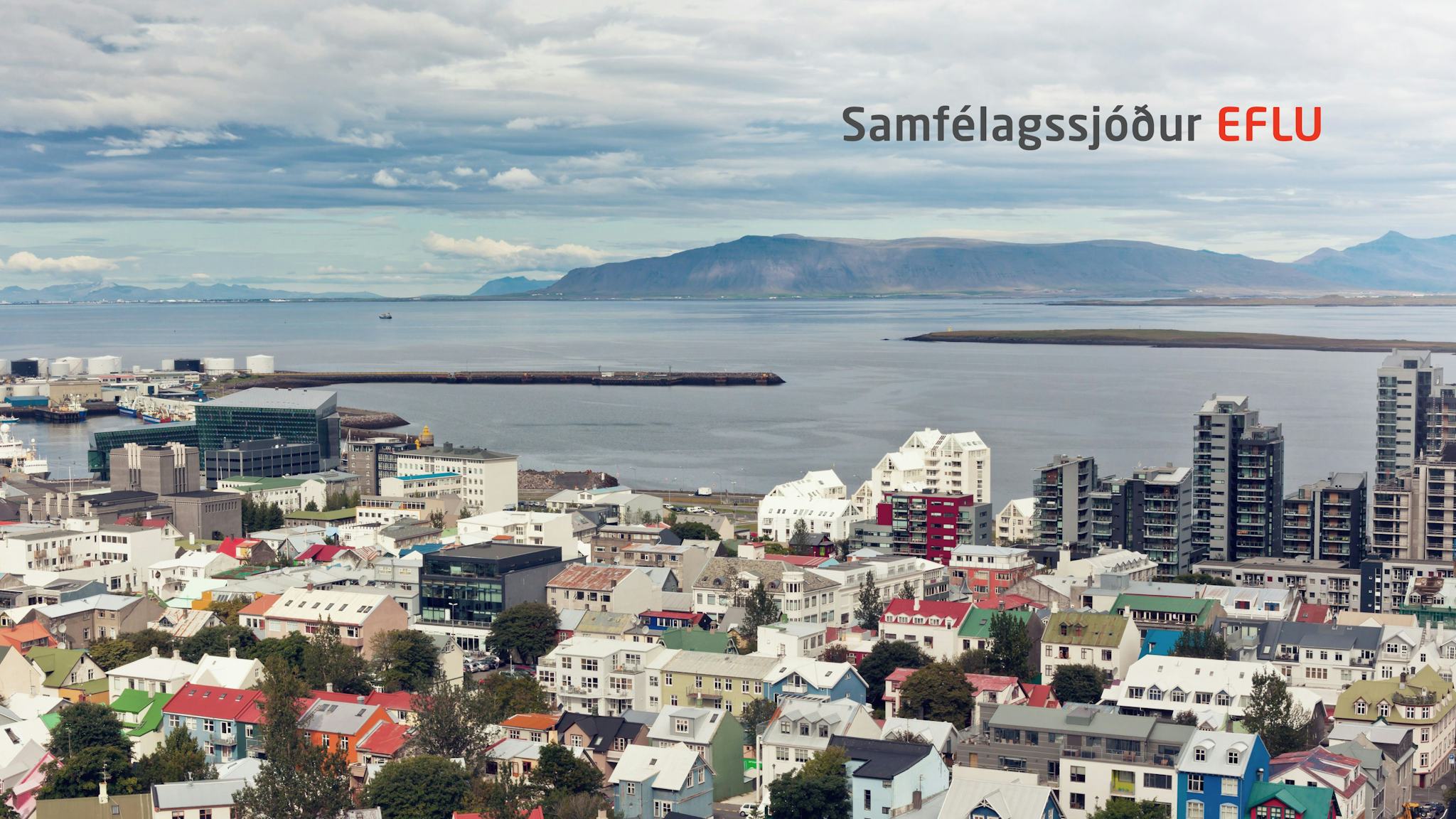A bird eye view of colorful coastal city with some Icelandic text