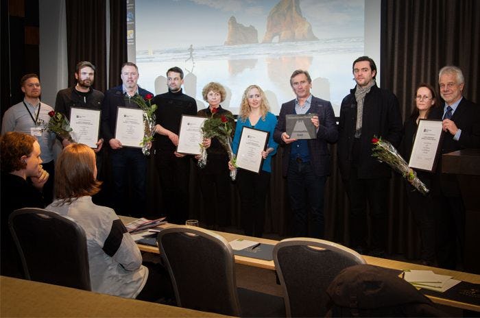 A group of men and women standing with certificates in their hands 