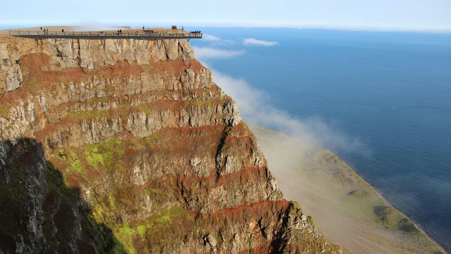 A cliff overlooking  a sea