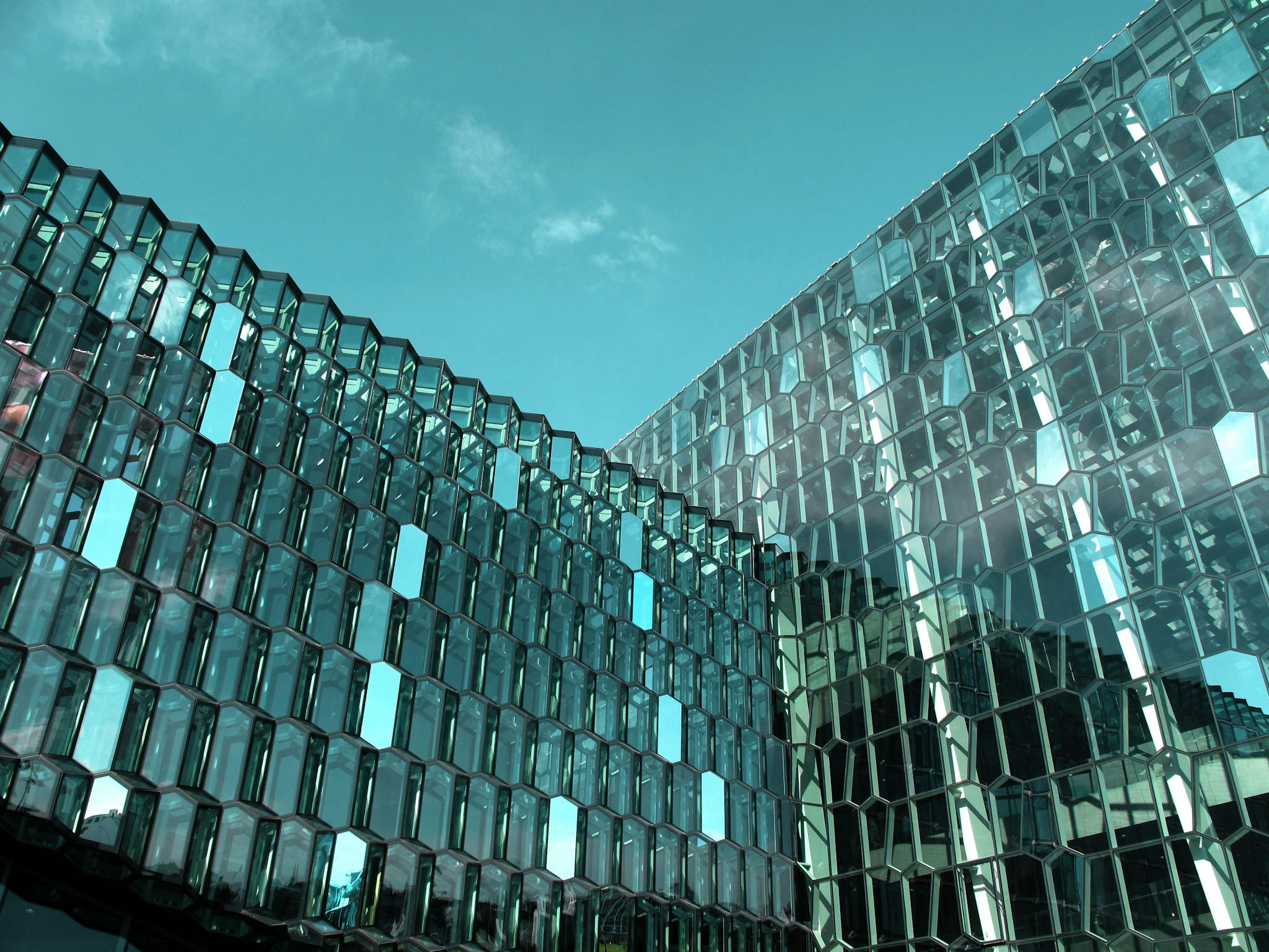 A close-up photo of a modern building with distinct geometric glass panel design