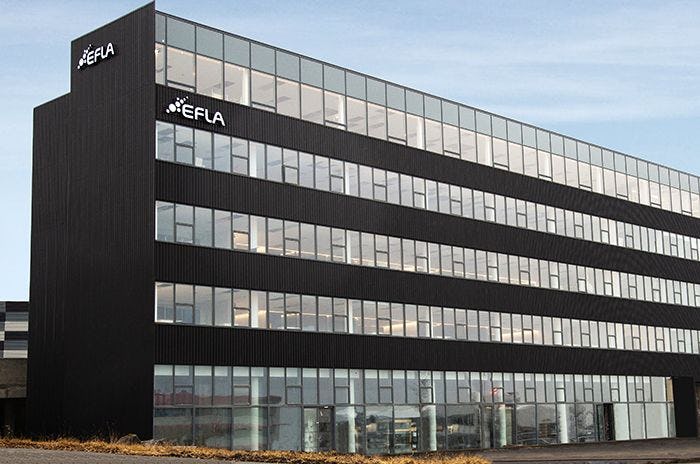 A modern building with large windows and name "EFLA" on its facade