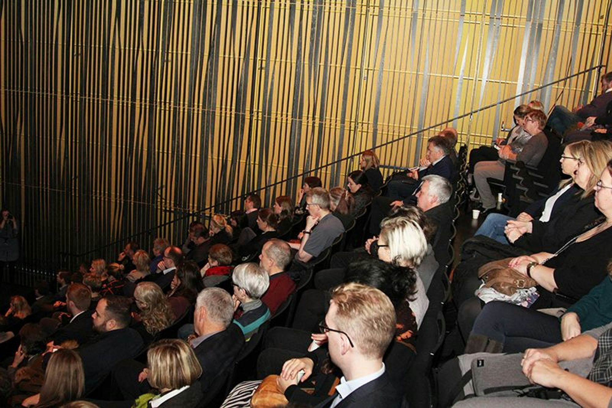  group of people seated in an auditorium 
