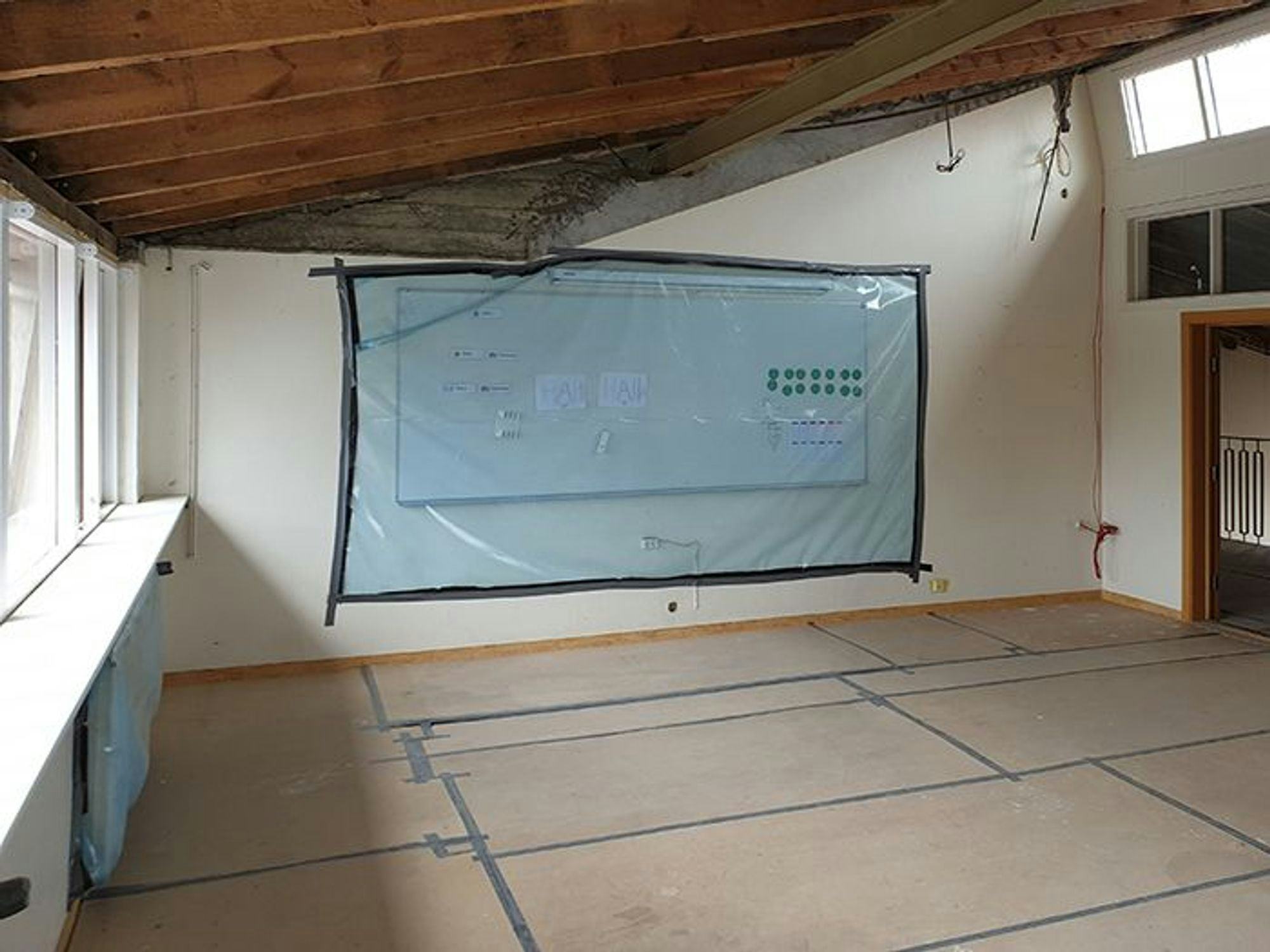 an interior space of a room under construction, with insulation material visible 