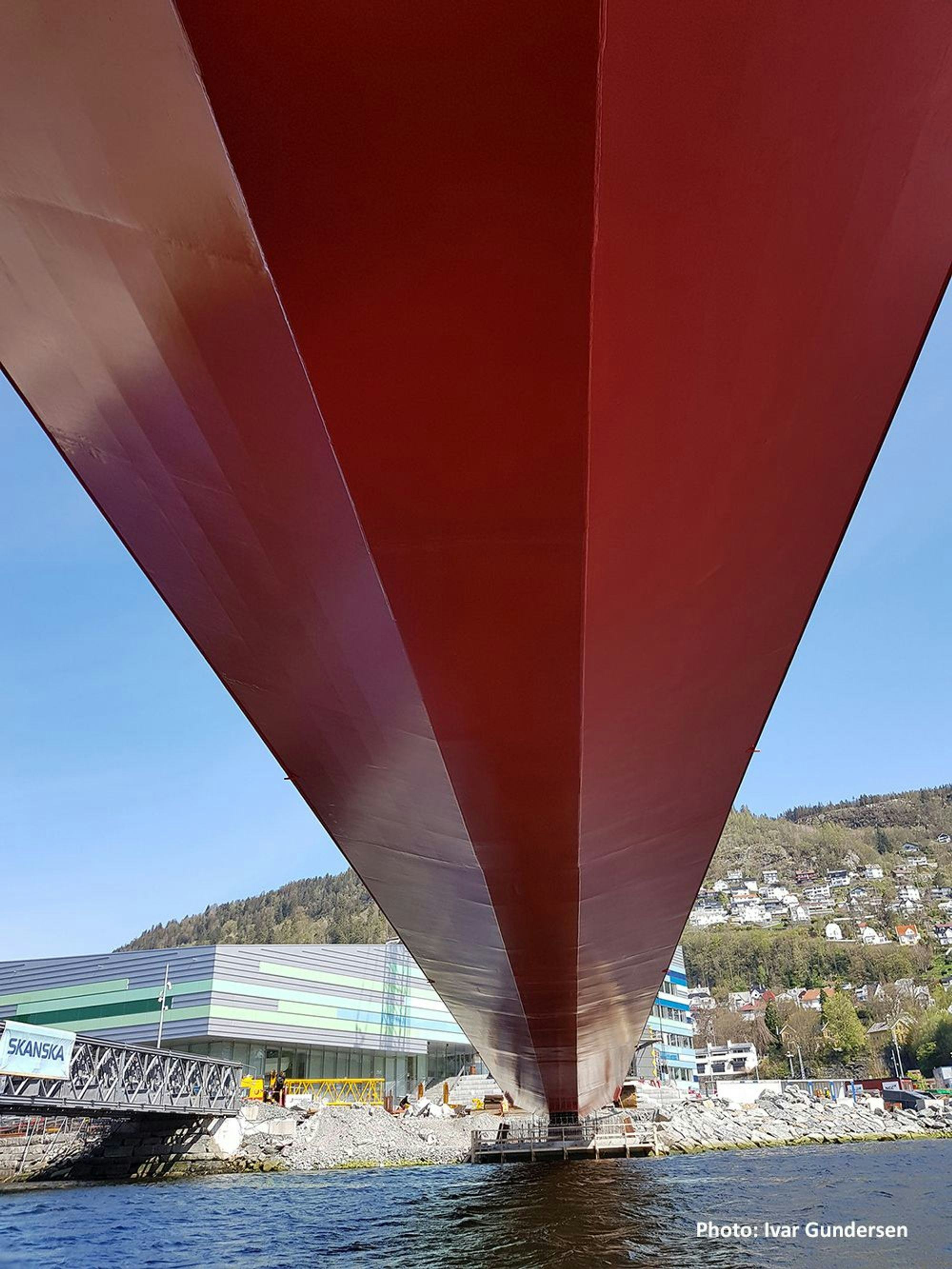 The underside of a large red bridge