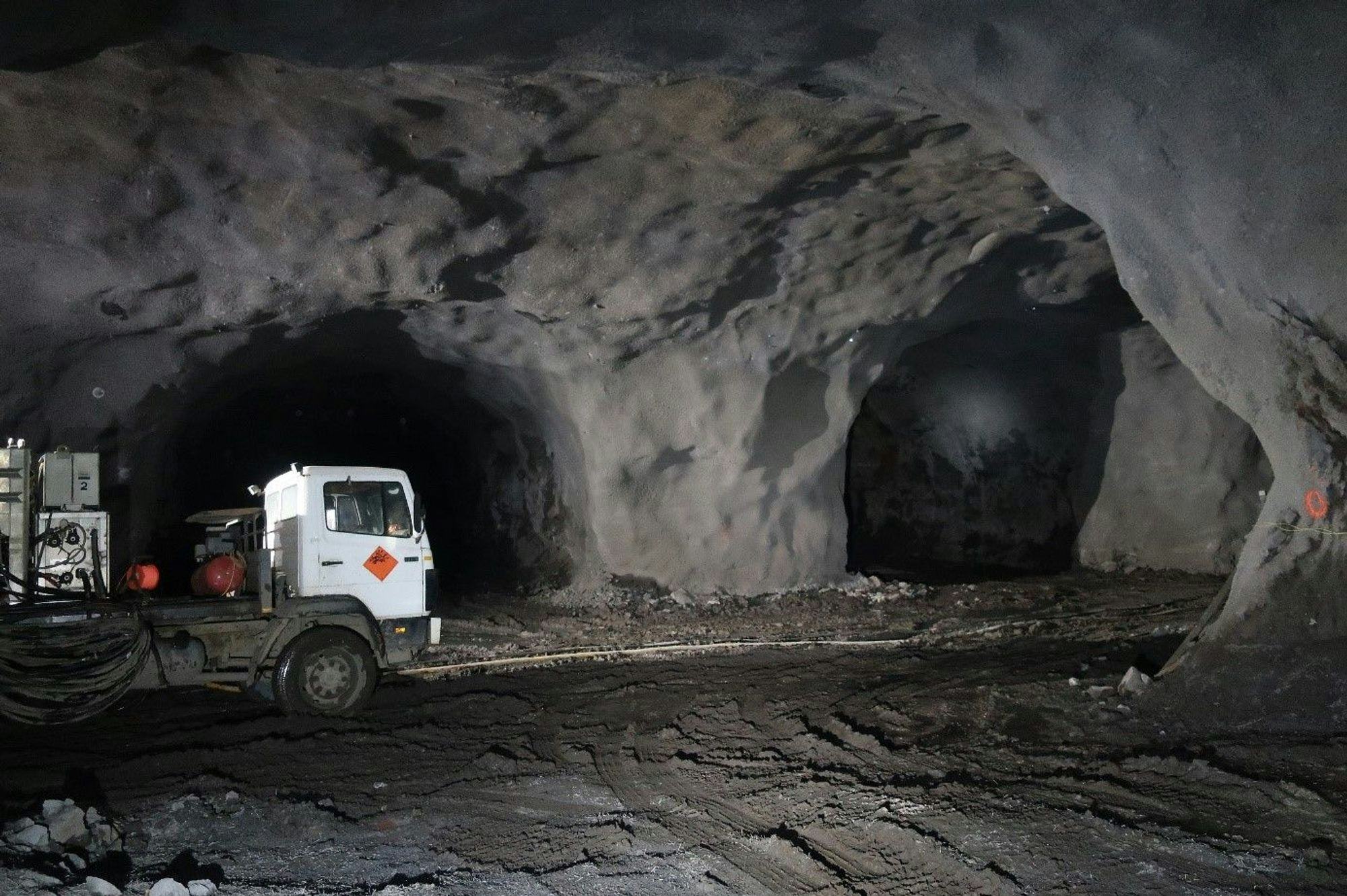 A white truck inside a large illuminated tunnel