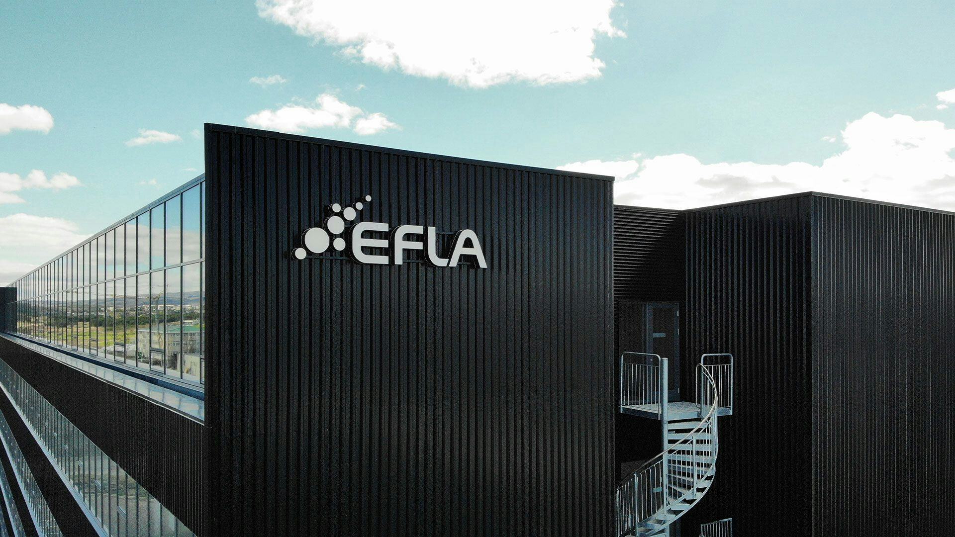 A modern building with large windows and name "EFLA" on its facade