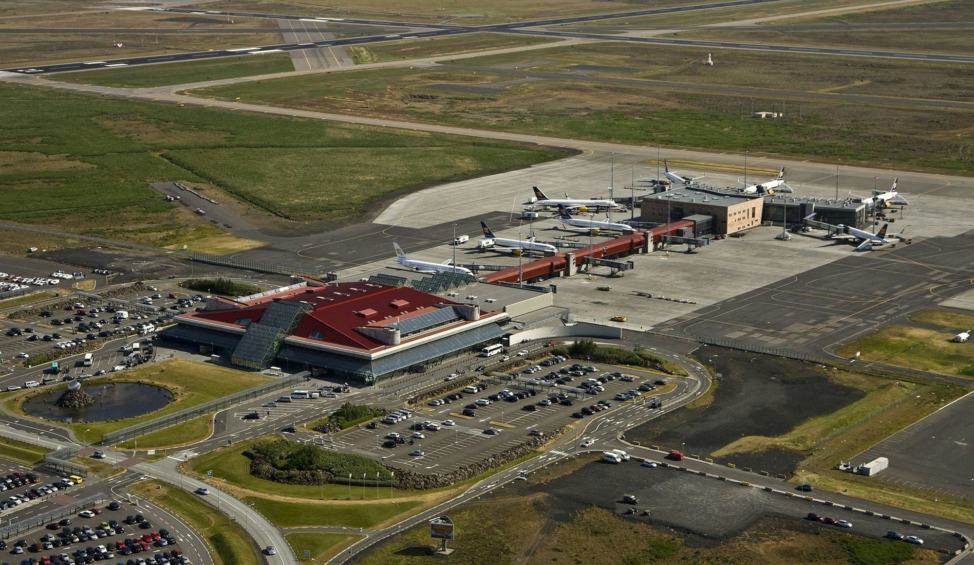 Aerial photo of an airport showcasing runway, aircrafts and airport building