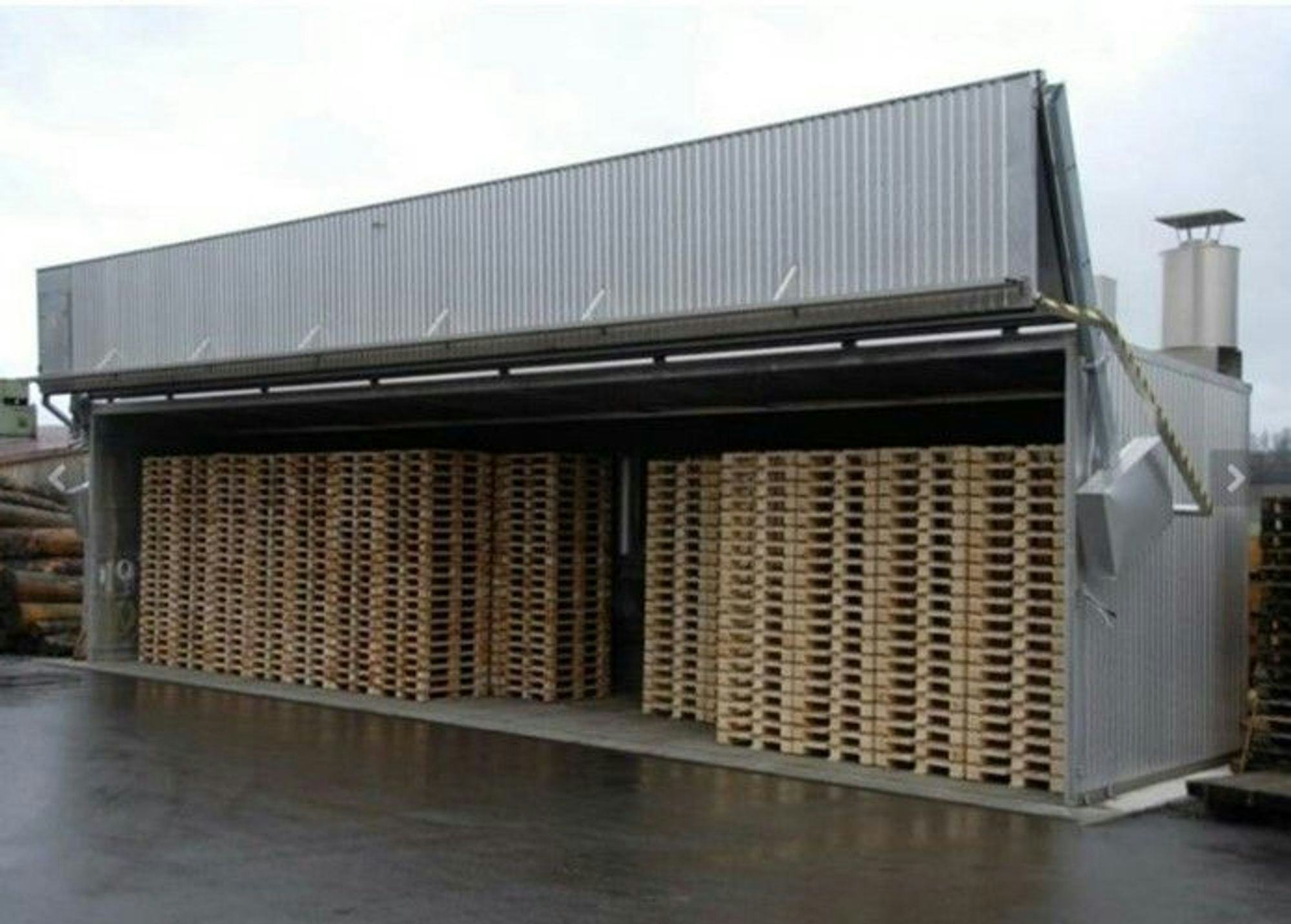 large industrial container filled with multiple layers of wooden pallet