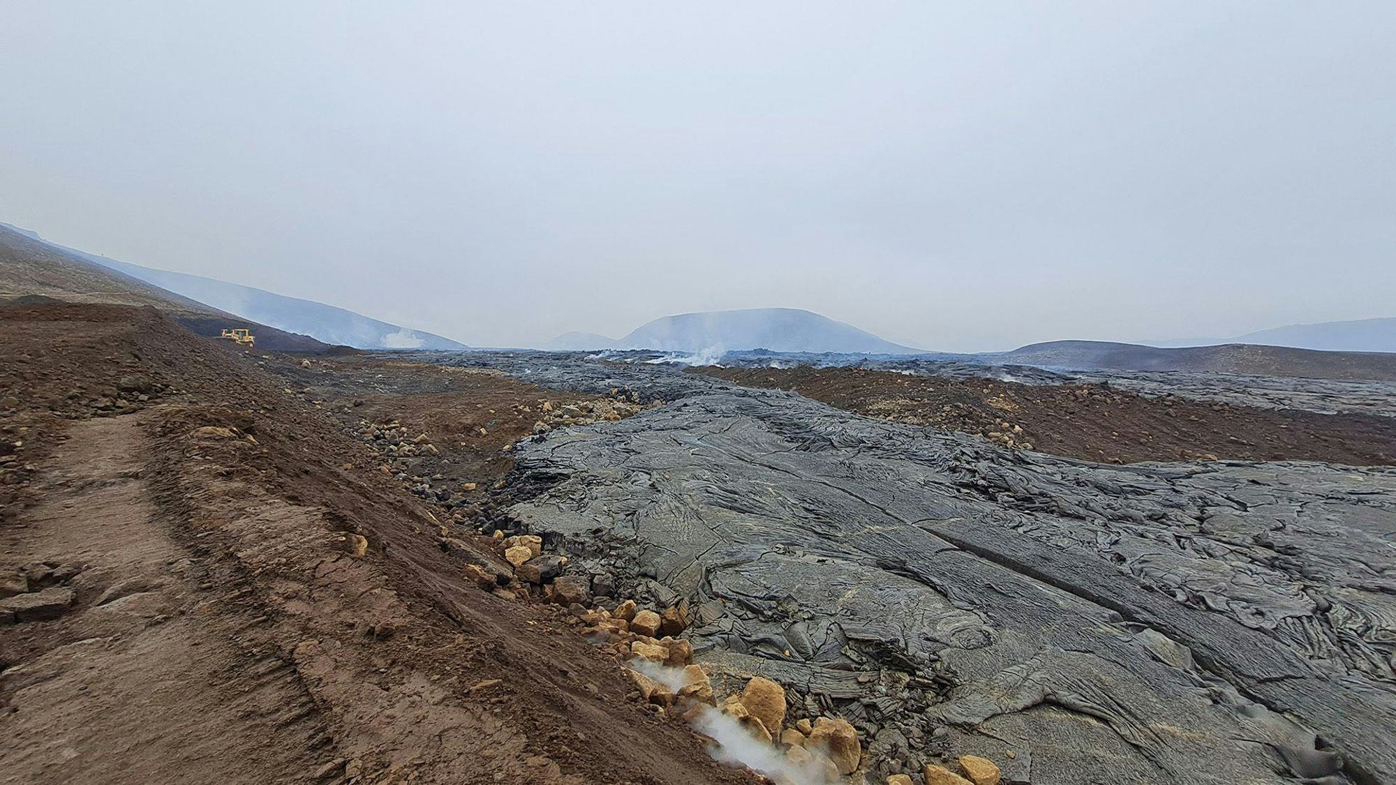 A landscape featuring dark, hardened lava flow 